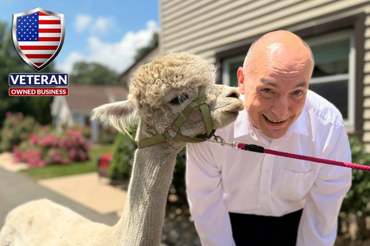 Shady Oaks owner Tyson Belanger with an alpaca outside the home — Connecticut’s only family- and veteran-owned assisted living